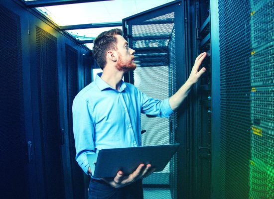 IT technician performing server diagnostics in data center